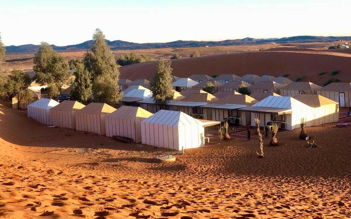 Tents of a desert camp pitched on the sand at Erg Chebbi