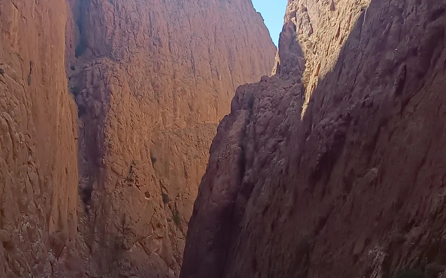 Narrow red rock walls of a gorge on the road to the desert