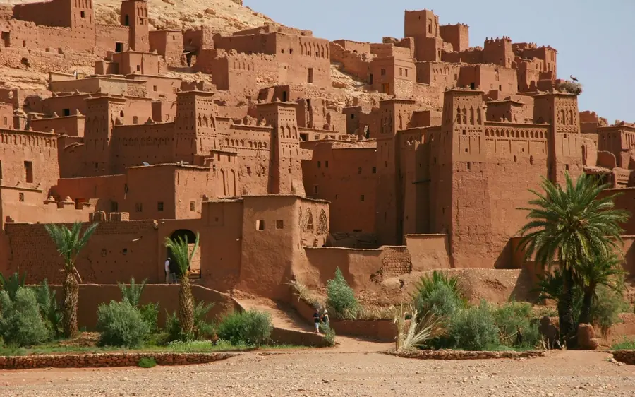 The earthen kasbah of Ait Ben Haddou above palm trees